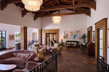 A room with a fireplace, a painting, and a lamp. at Inn At Rancho Santa Fe