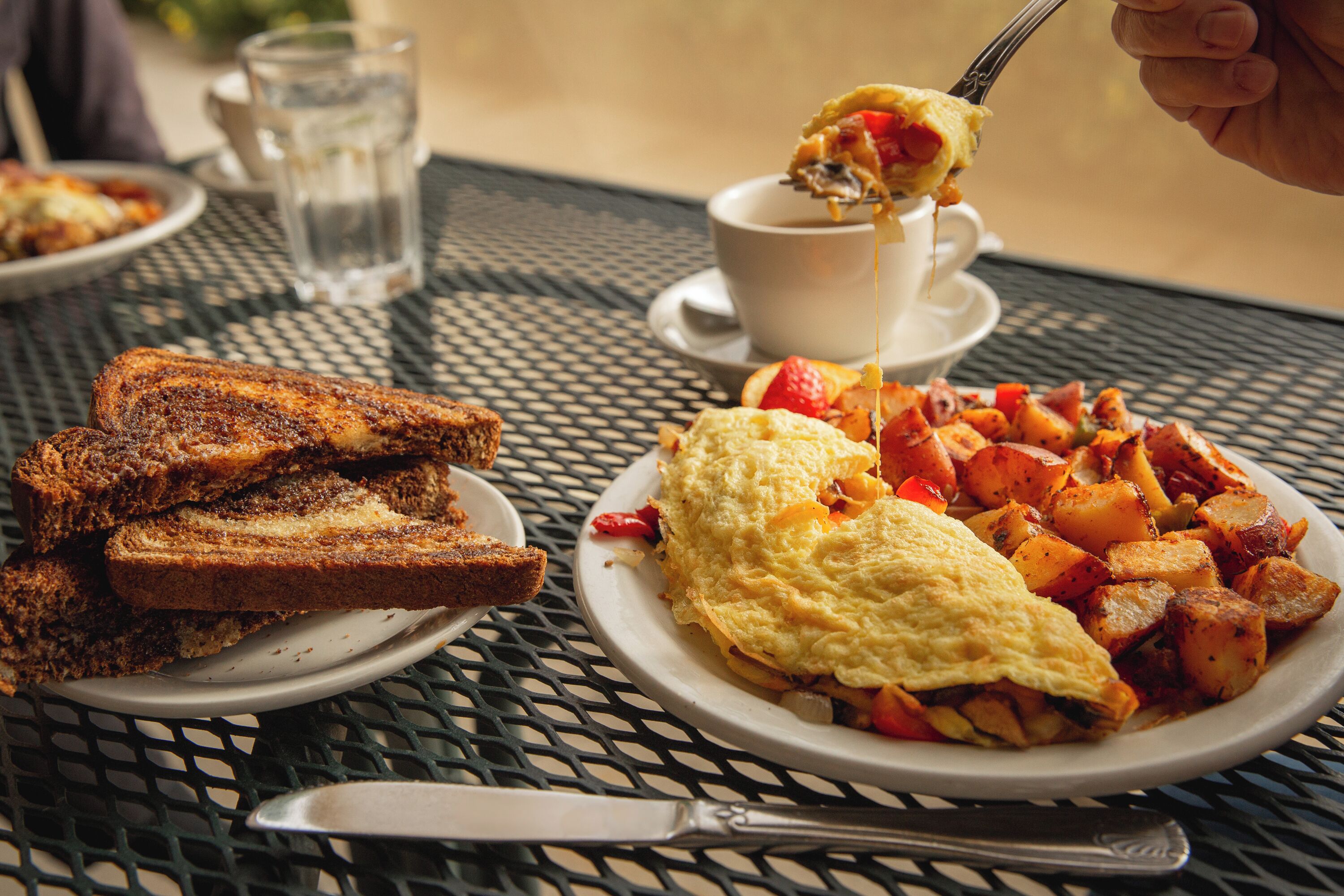 A breakfast plate with toast, eggs, and potatoes.