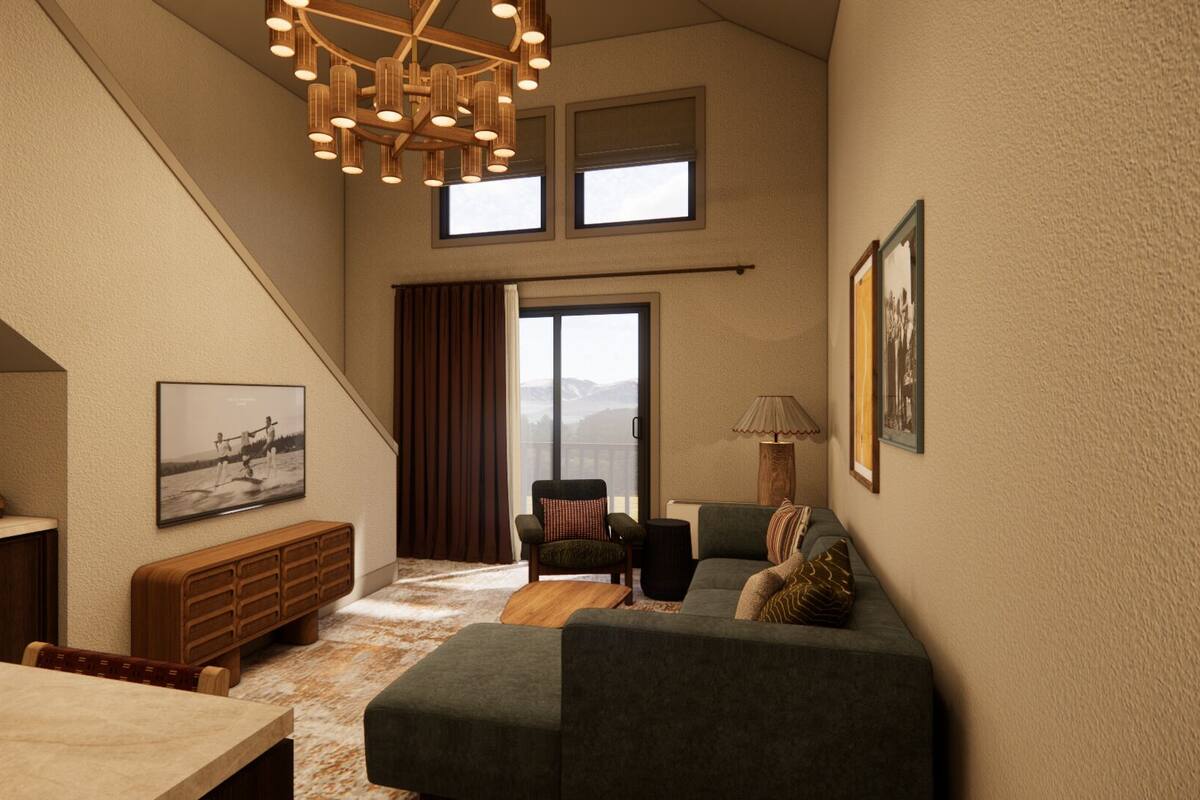 A cozy living room with a sofa, a dining table, and a staircase leading to a balcony.