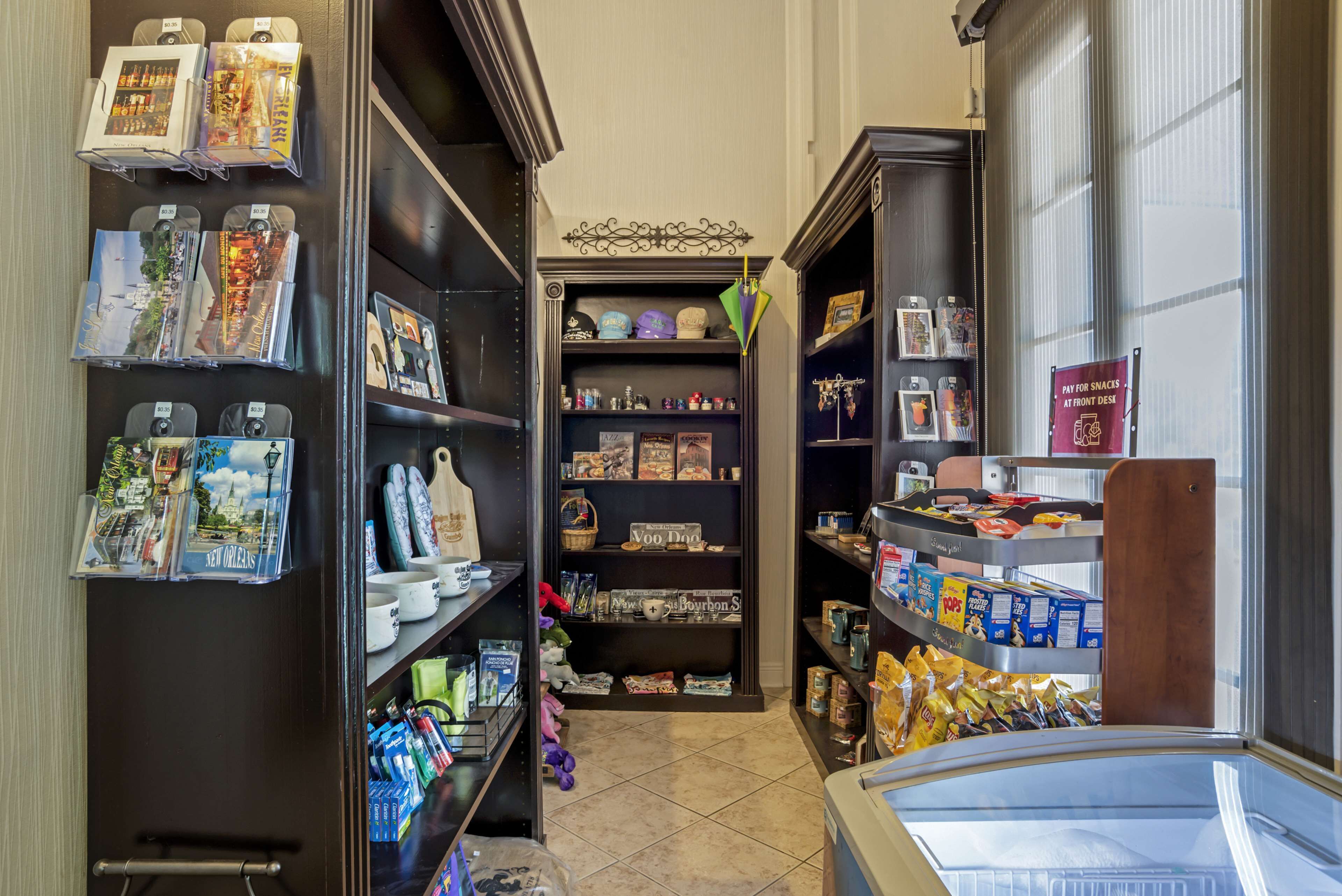 A narrow hallway with shelves on both sides displaying various items.