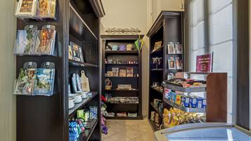 A narrow hallway with shelves on both sides displaying various items.