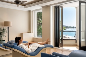 A room with two beds, a view of the ocean, and a balcony with a railing. at Moana Surfrider, A Westin Resort & Spa, Waikiki Beach