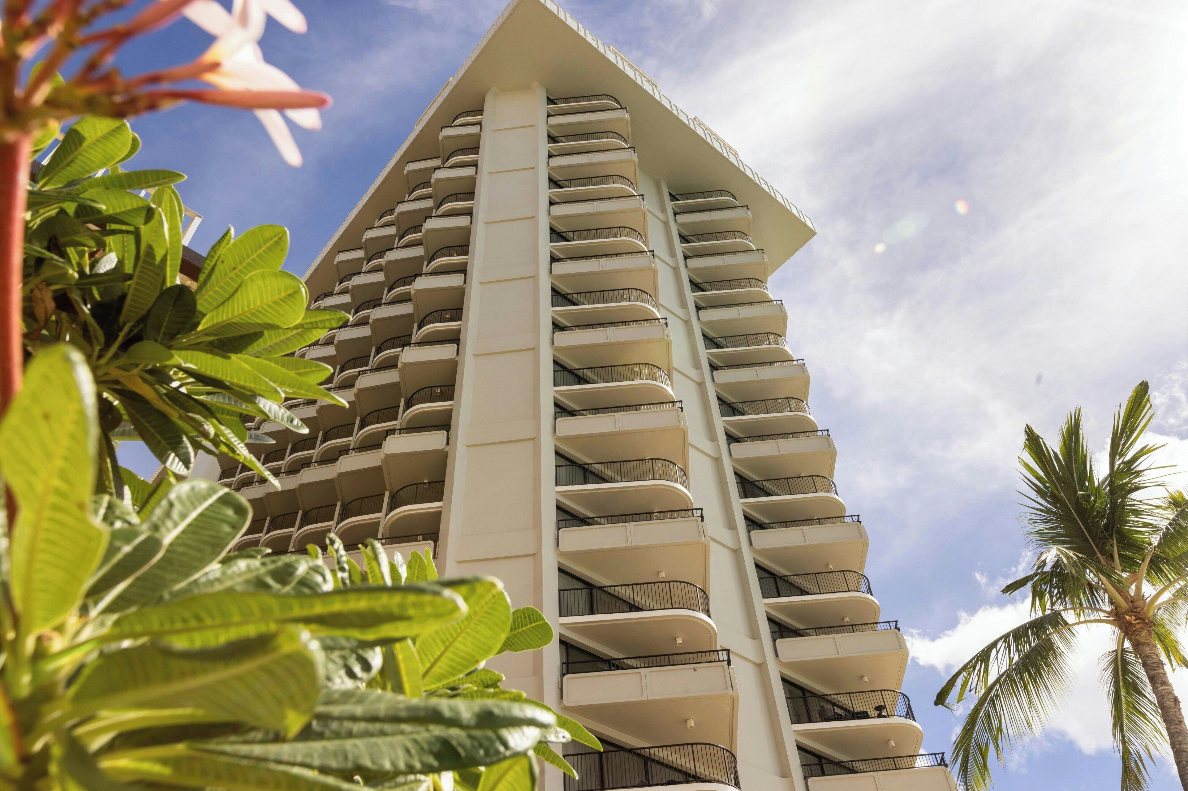 A high-rise hotel with multiple balconies and a modern architectural design.