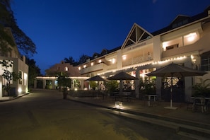 A hotel with outdoor seating and a sign reading "The Normandie". - The Normandie Hotel (Port of Spain)