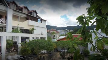 A multi-story building with balconies and outdoor seating areas.