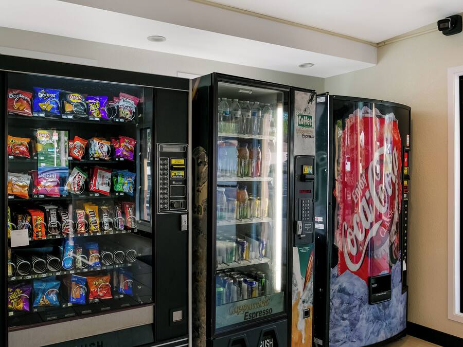 A vending machine with snacks and a Coca-Cola machine.