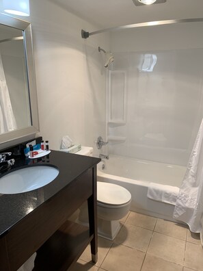 A bathroom with a sink, toilet, and bathtub.