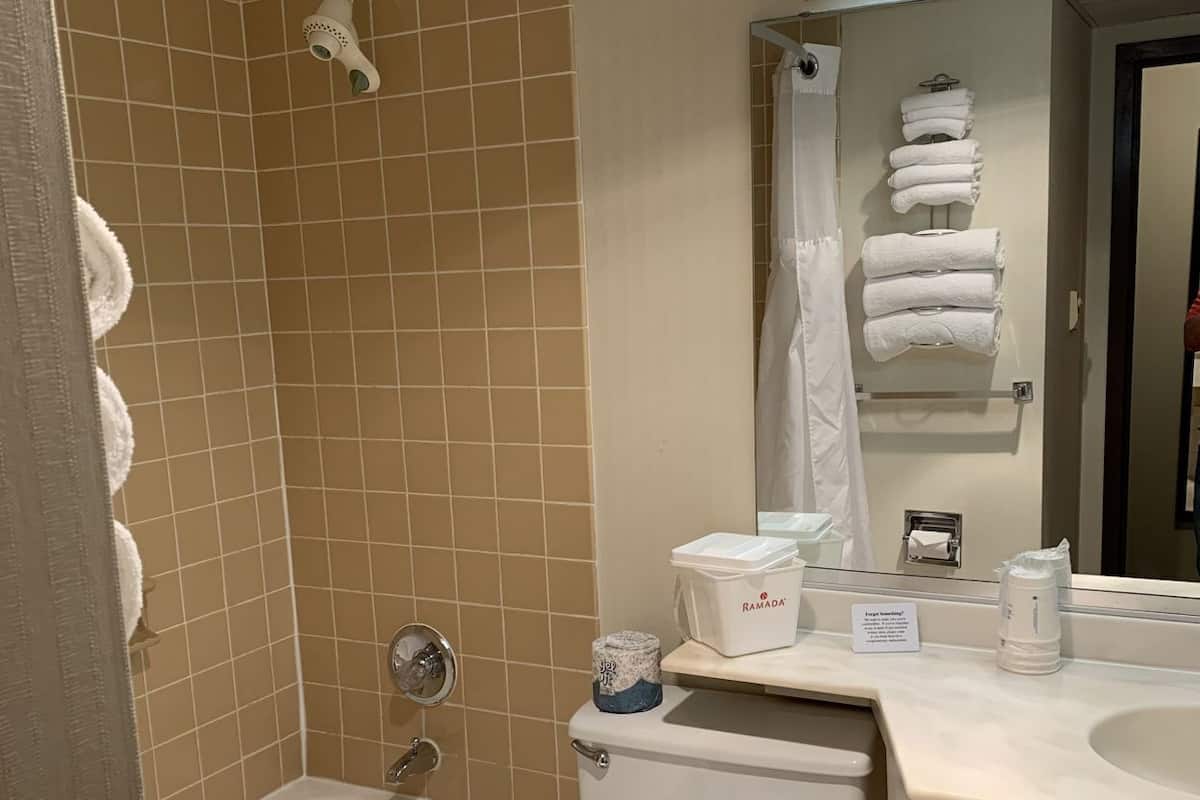 A bathroom with a bathtub, toilet, and sink.