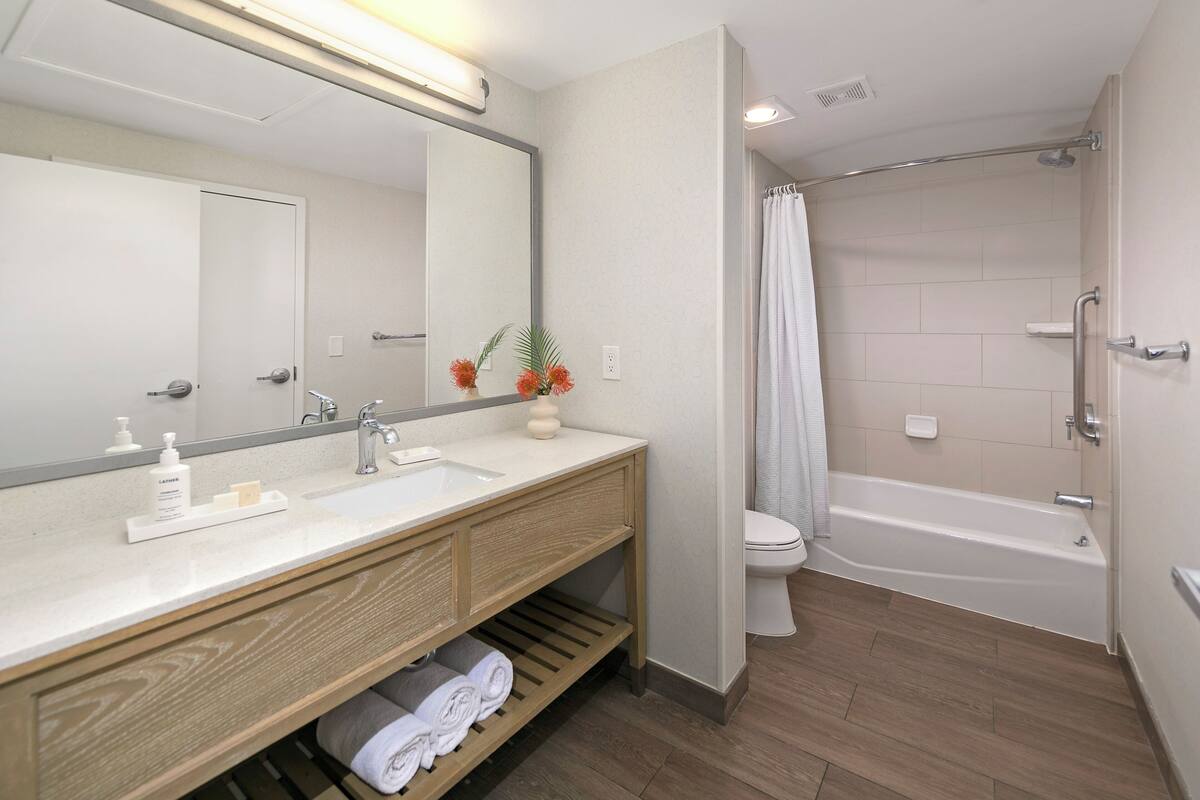 premium suite, 1 king bed, lanai, pool view | bathroom | designer toiletries, hair dryer, towels, soap