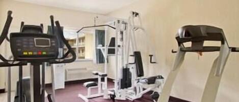 A gym with cardio equipment, weight machines, and a treadmill.