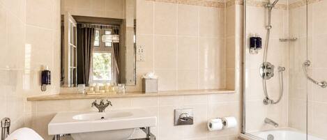 A bathroom with a sink, toilet, and shower.