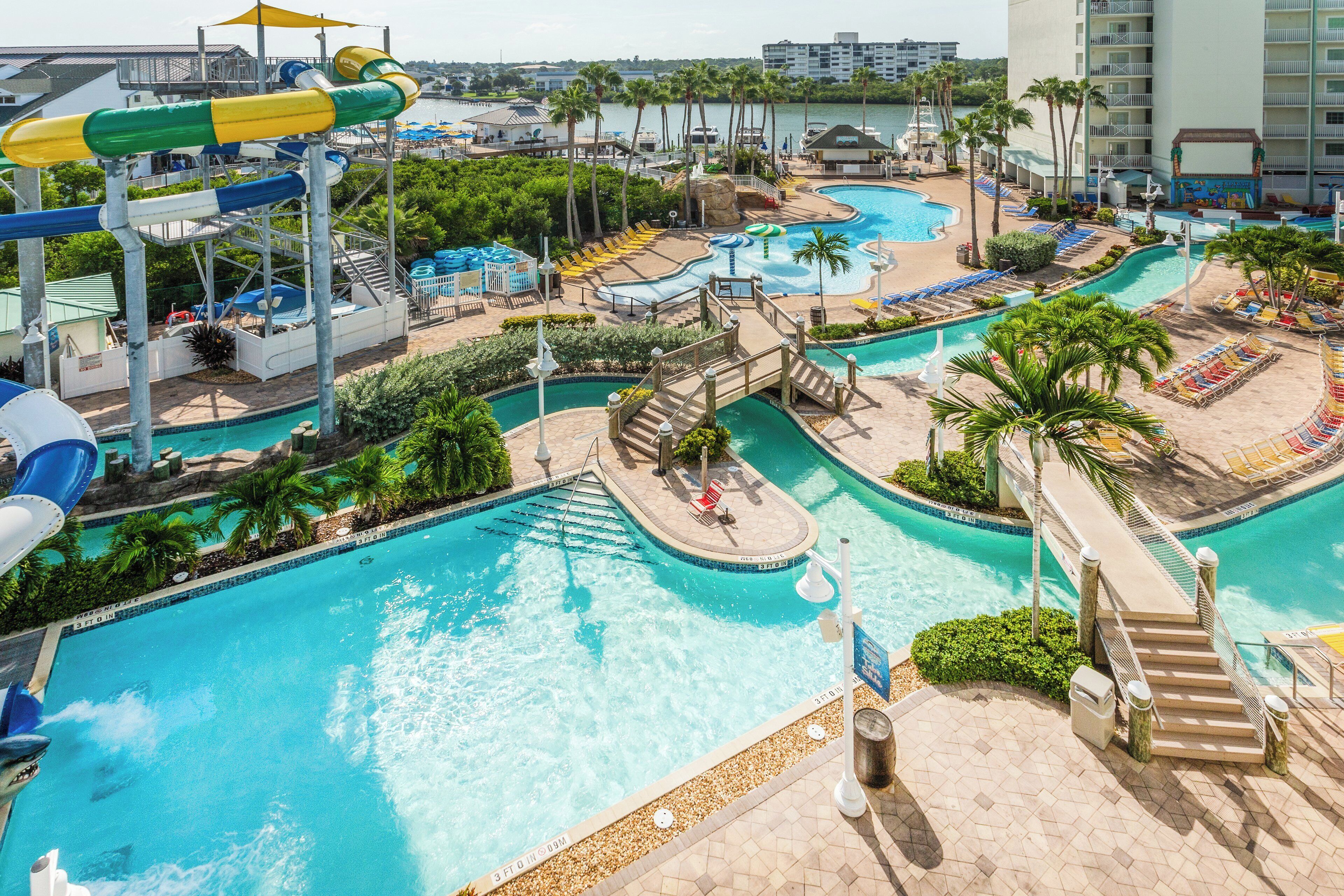 A resort with multiple swimming pools, water slides, and a marina.