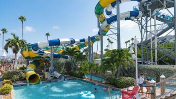 A water park with multiple slides and a swimming pool.