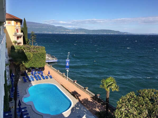 Seasonal outdoor pool, open 8:00 AM to 7:00 PM, pool umbrellas