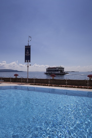 Seasonal outdoor pool, open 8:00 AM to 7:00 PM, pool umbrellas