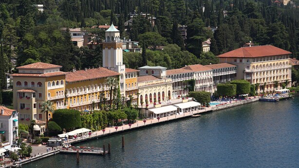 A waterfront hotel with multiple buildings, a dock, and a canal.