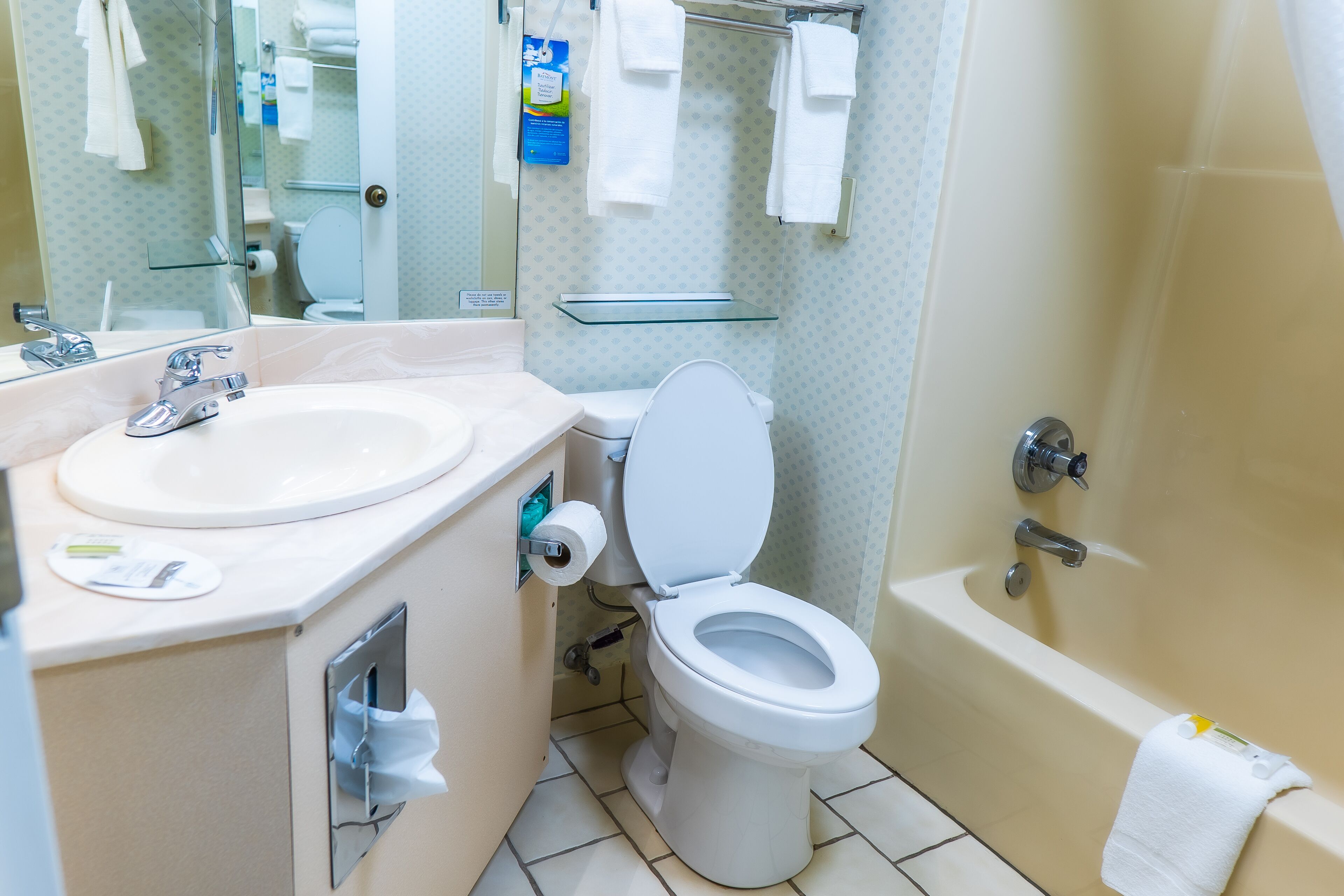 A bathroom with a white sink, toilet, and bathtub.