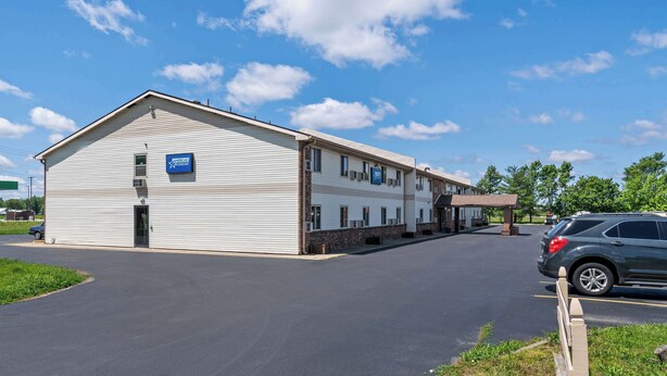 A two-story building with a large parking lot and a covered outdoor area.