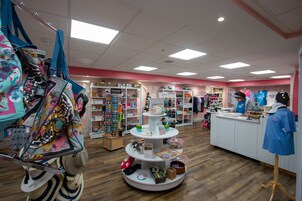 A retail store with a variety of hats and accessories on display.