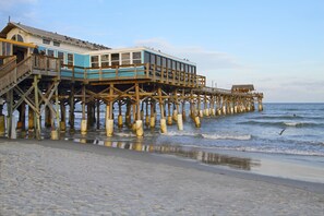 A wooden pier extending into the water with a building on it. - Days Inn by Wyndham Cocoa Beach Port Canaveral (Cocoa Beach)
