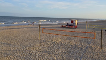 Enjoy a game of beach volleyball on our sandy court with a lifeguard nearby.