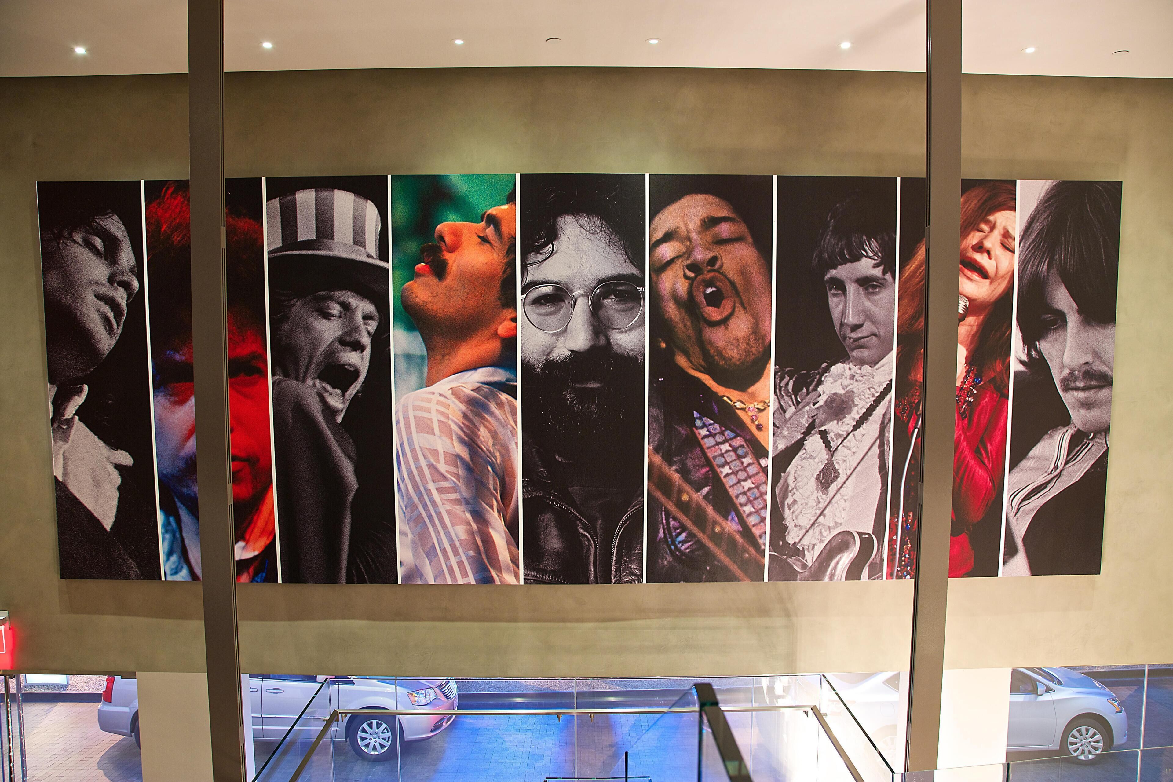 A series of portraits on a wall.