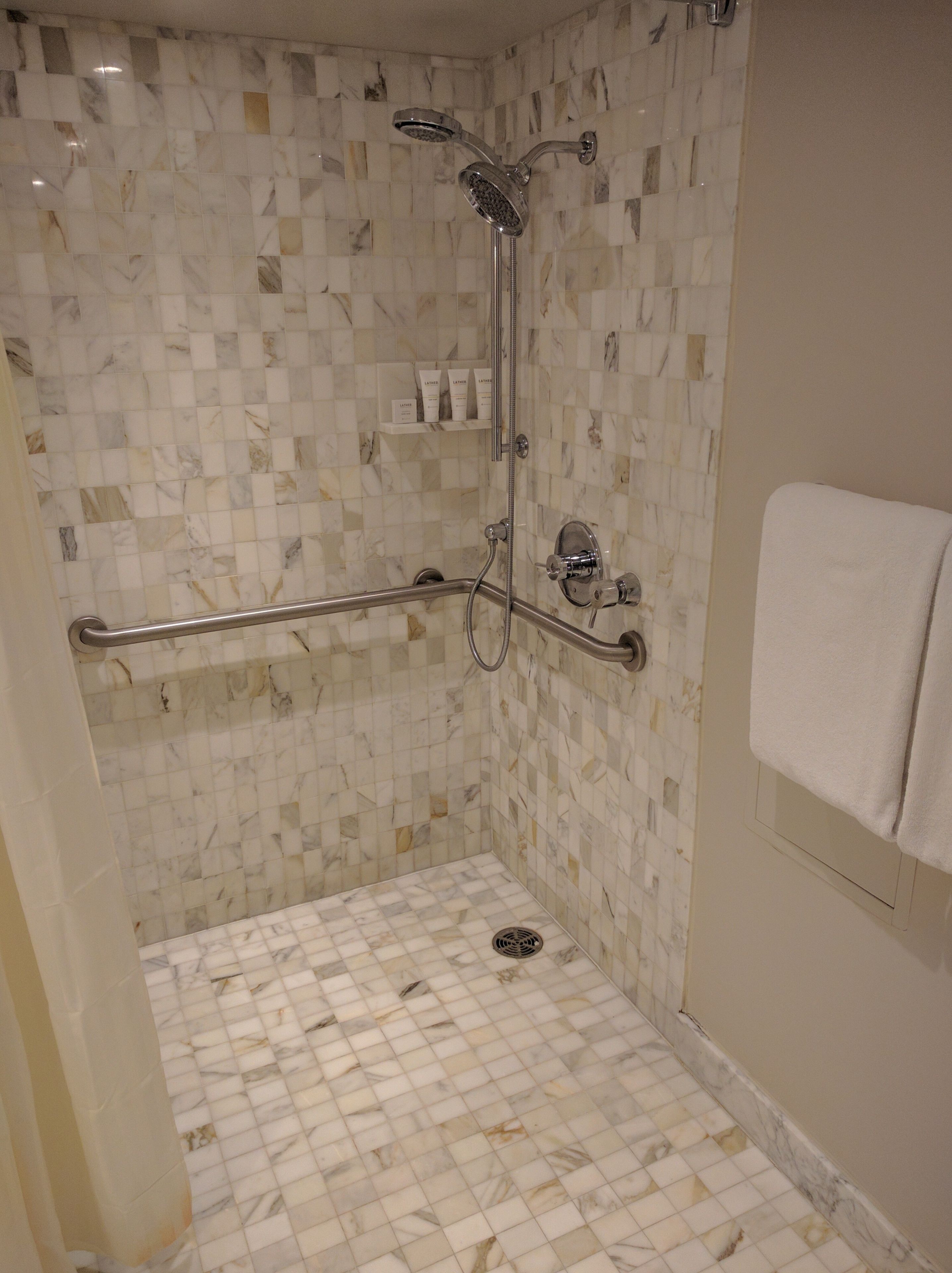 Shower, designer toiletries, hair dryer, towels