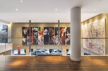 A modern hotel room with a dining area, a TV, and a view of the city. at ANDAZ WEST HOLLYWOOD, BY HYATT