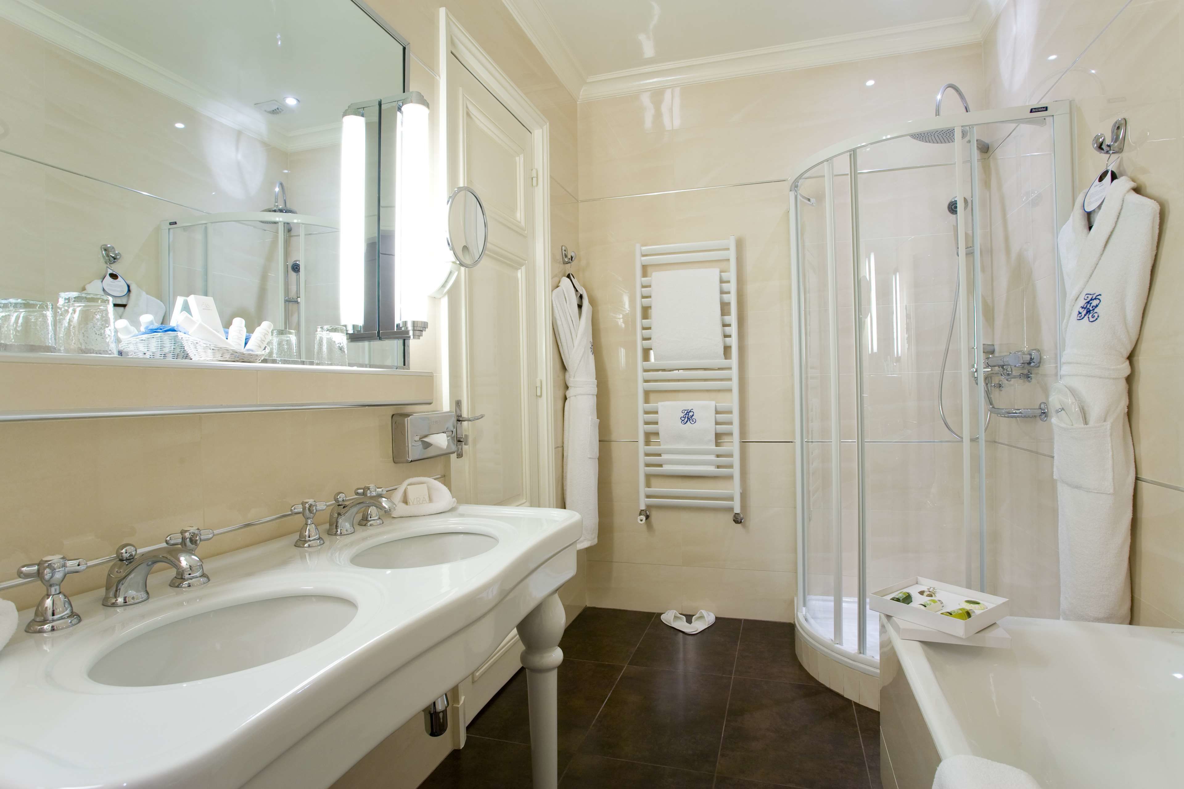 A bathroom with two sinks, a shower, and a bathtub.