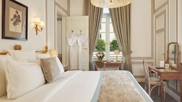 A hotel room with a large bed, a desk with a mirror, and a window with curtains.