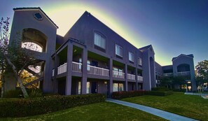 Residents enjoy balconies and a central courtyard with a pathway to the entrance.