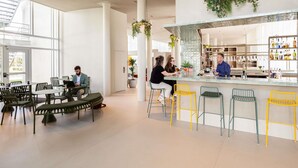 A modern interior with a bar area, seating, and a staircase leading to an outdoor area. - ibis Styles Brugge Centrum (Bruges)