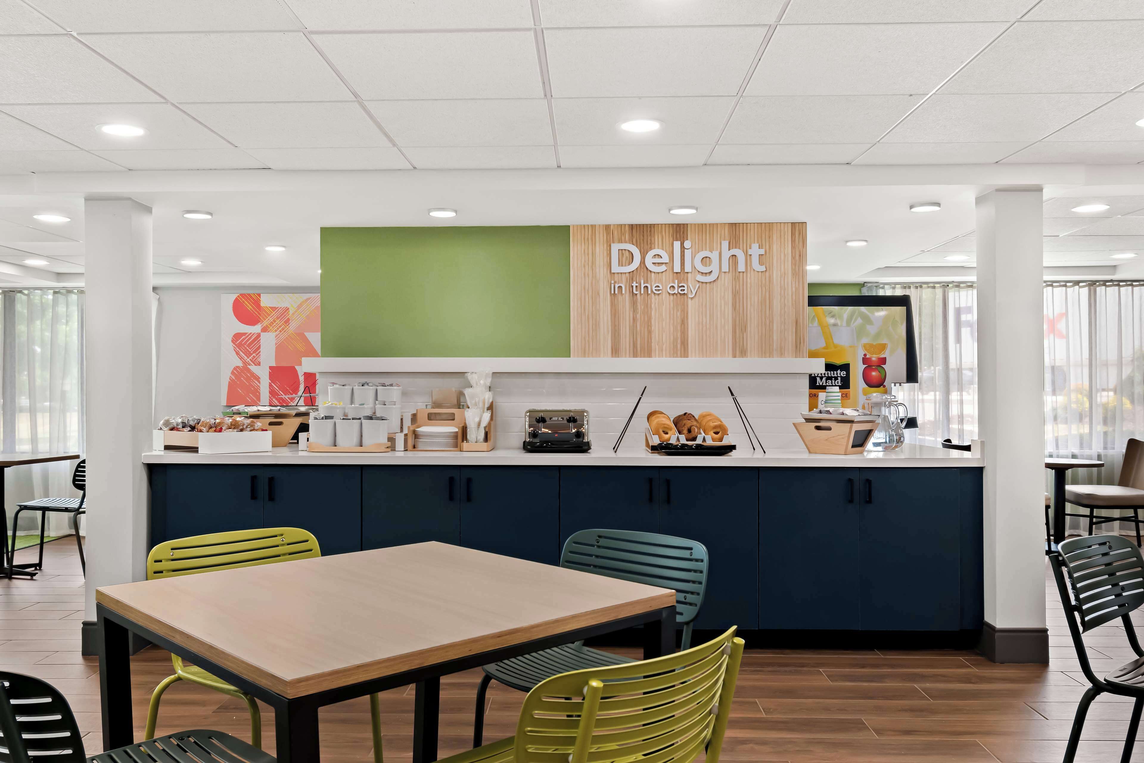 Una cocina moderna con un mostrador que exhibe diversos alimentos y un letrero que dice 'Delight in the day'.