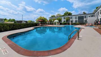 Seasonal outdoor pool, open 9:00 AM to 9:00 PM, pool umbrellas