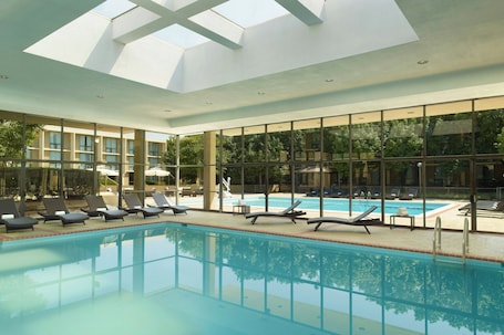 Indoor pool, seasonal outdoor pool, pool umbrellas, pool loungers