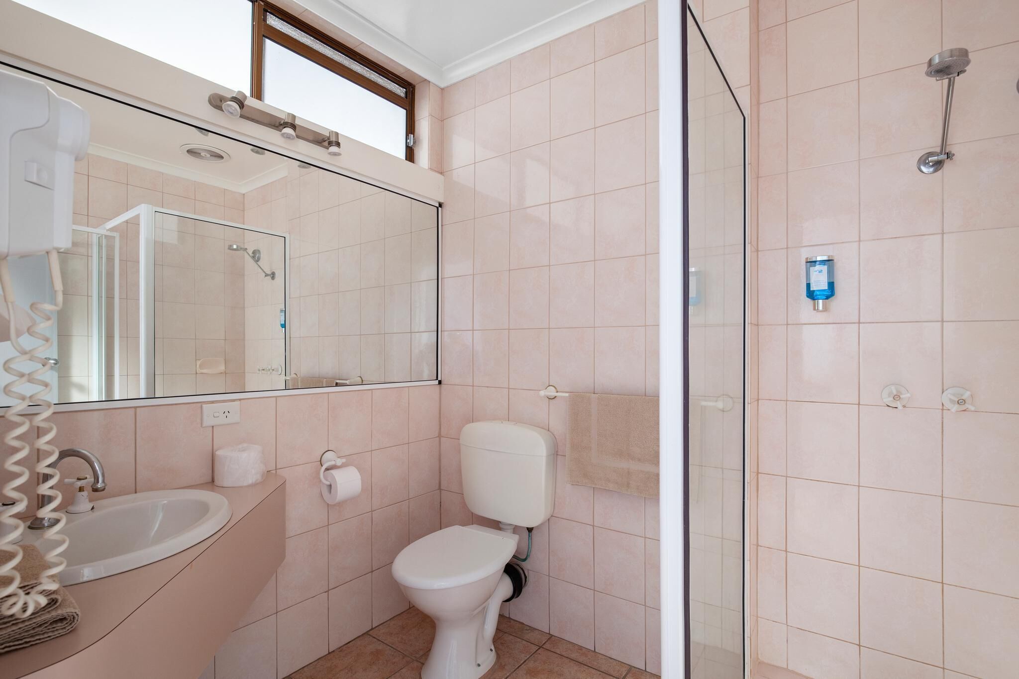 A bathroom with a sink, toilet, and shower.