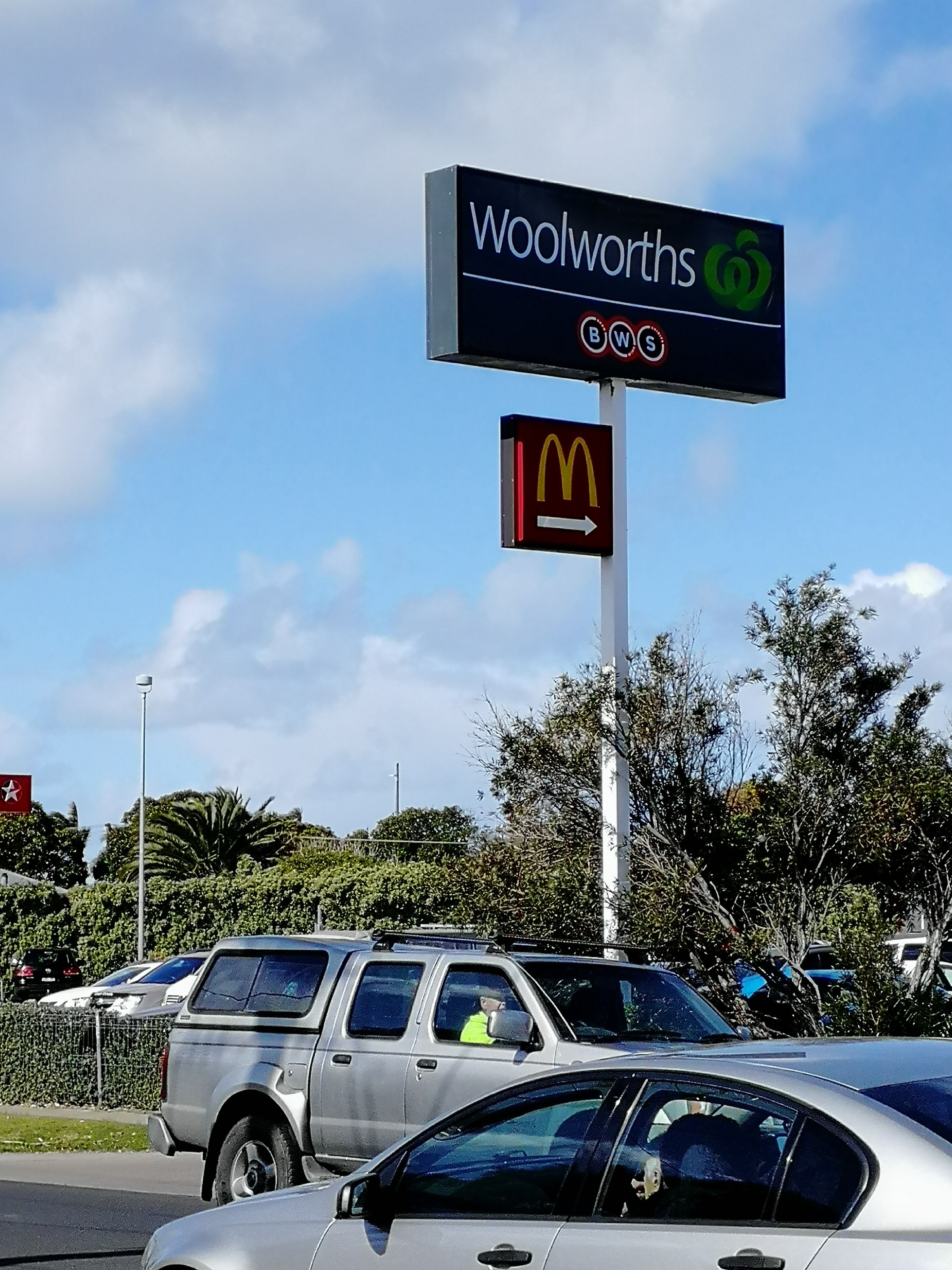 A sign for Woolworths and a McDonald's sign.