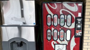 A vending machine with multiple beverage options including Coca-Cola, Sprite, and Diet Coke. - Red Roof Inn Rockingham (Rockingham)