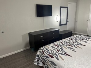 Desk, laptop workspace, blackout drapes, iron/ironing board