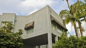 Un bâtiment moderne doté d’un toit plat, de grandes fenêtres et d’un espace d’entrée abrité.