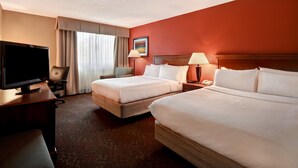 A hotel room with two beds, a TV, a desk, and a chair. - Holiday Inn Cincinnati-Riverfront by IHG (Covington)
