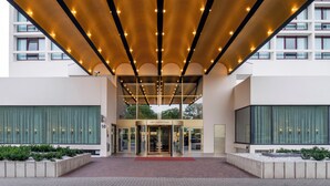 A hotel entrance with a covered entrance, a revolving door, and a sign reading "Crown Plaza". - Crowne Plaza Antwerp by IHG (Antwerp)