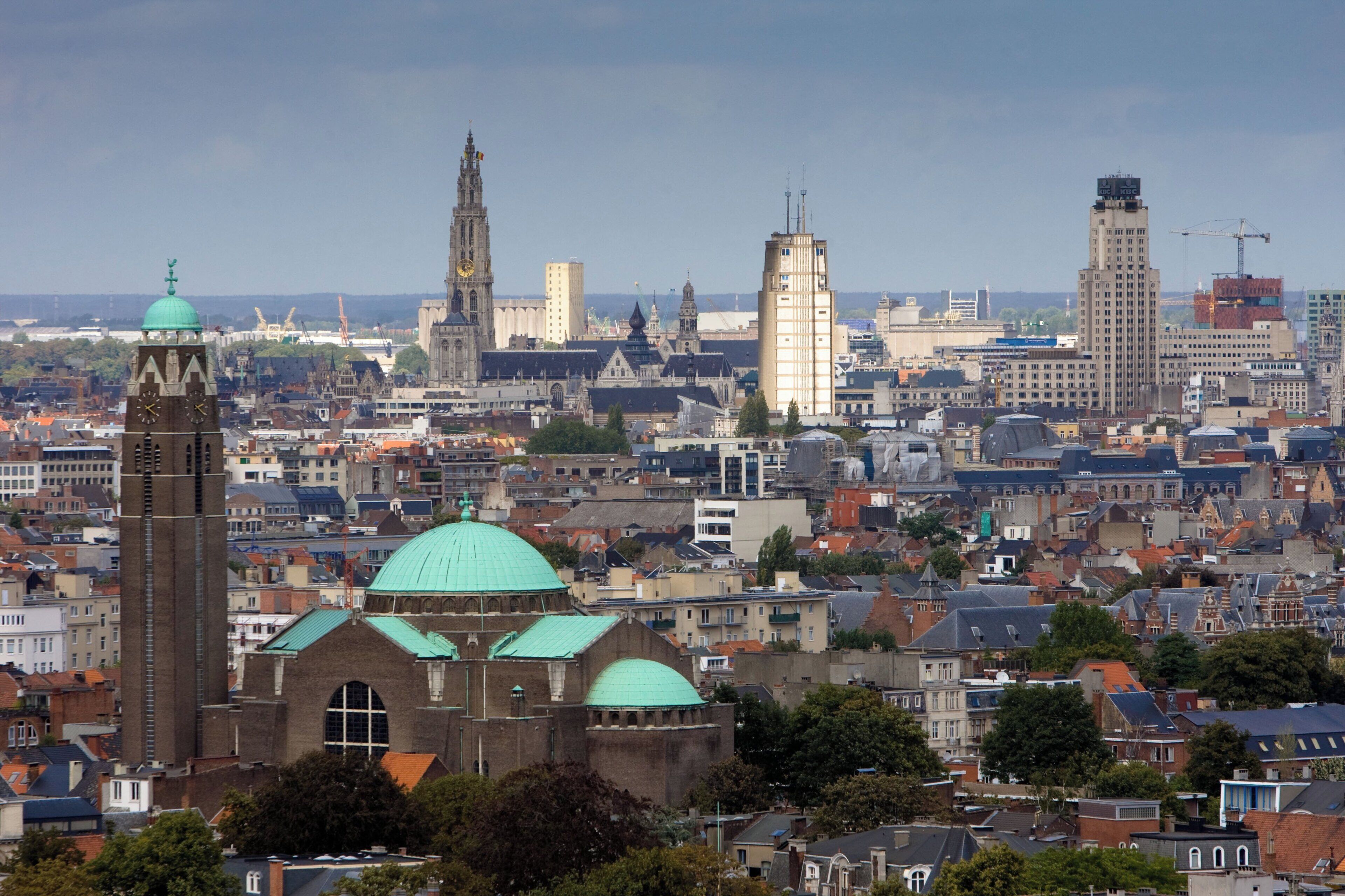 A cityscape with historic buildings and a prominent church with a green dome.