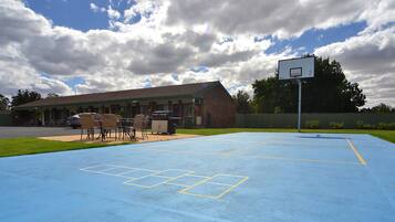 A basketball court with a building in the background.