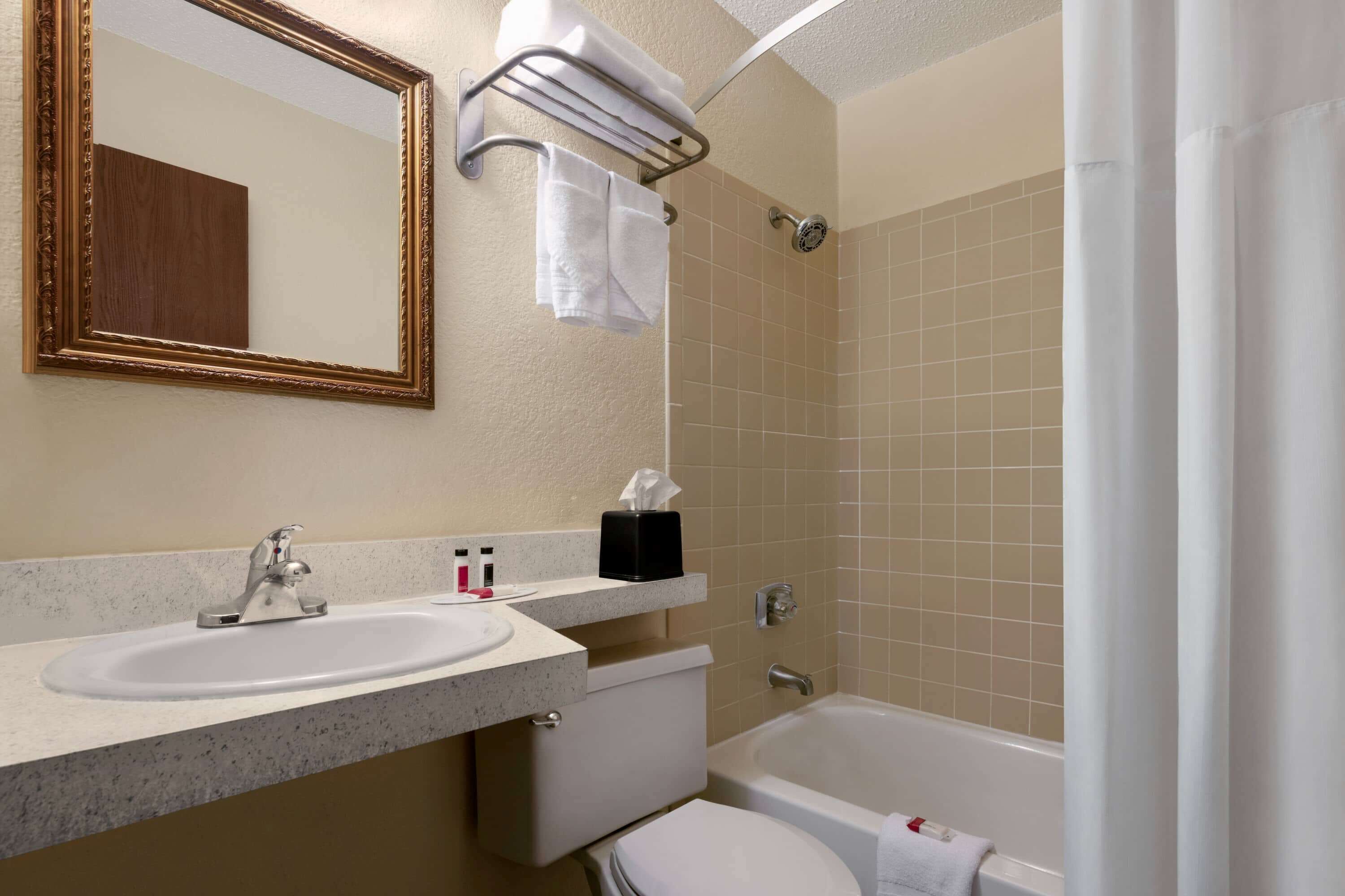 A bathroom with a sink, toilet, and bathtub.