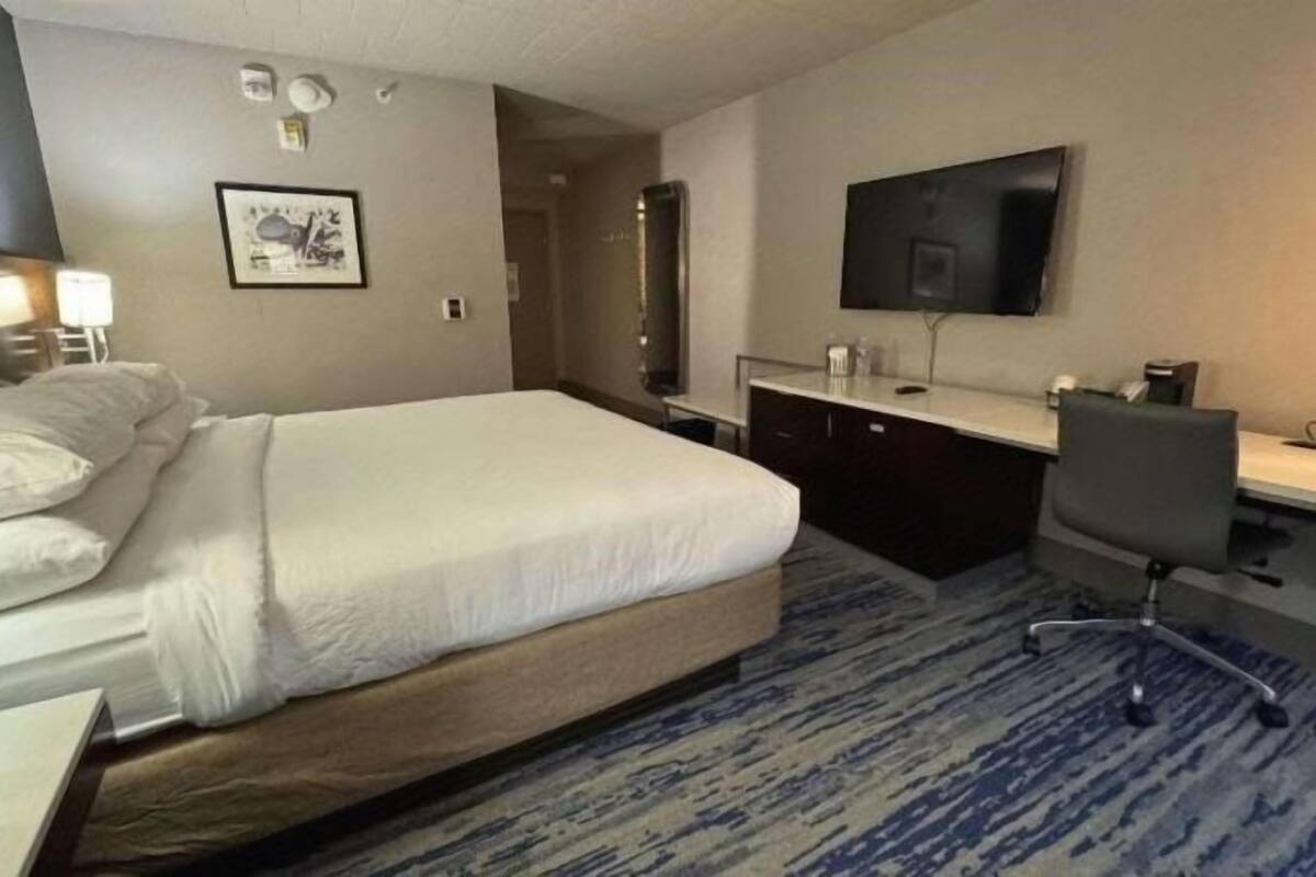 Premium bedding, desk, laptop workspace, blackout curtains