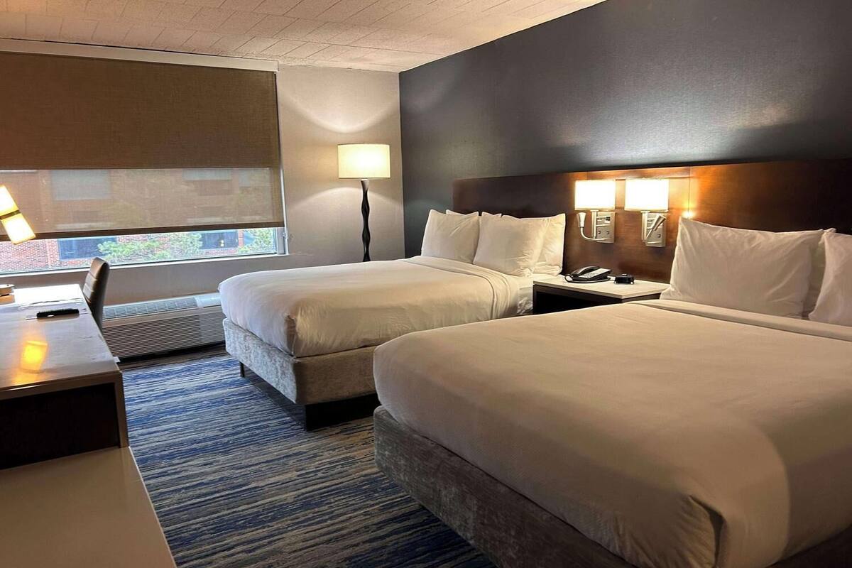 Premium bedding, desk, laptop workspace, blackout curtains