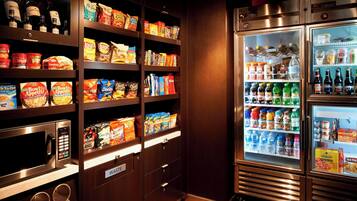 A well-stocked snack and beverage refrigerator with various food items and drinks.