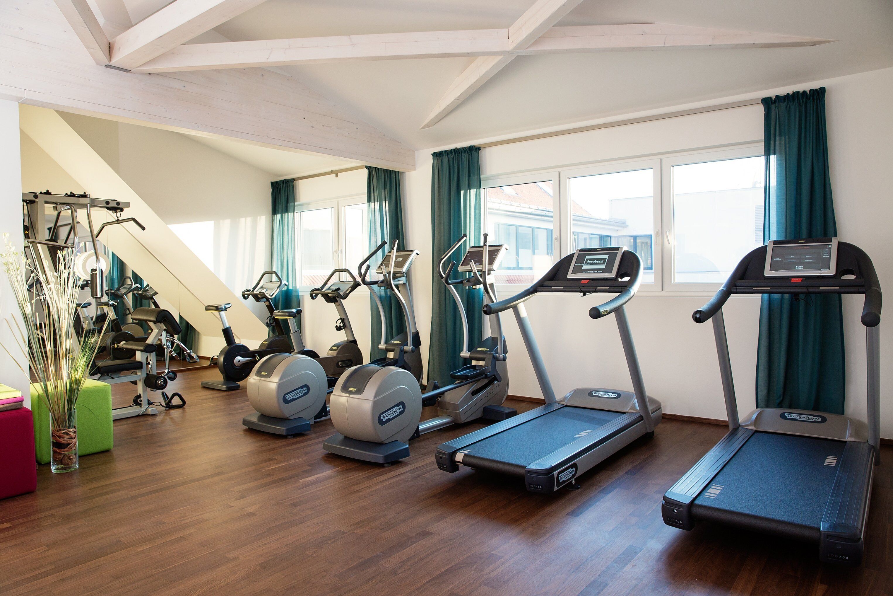 A gym with treadmills, elliptical machines, and a stair climber.