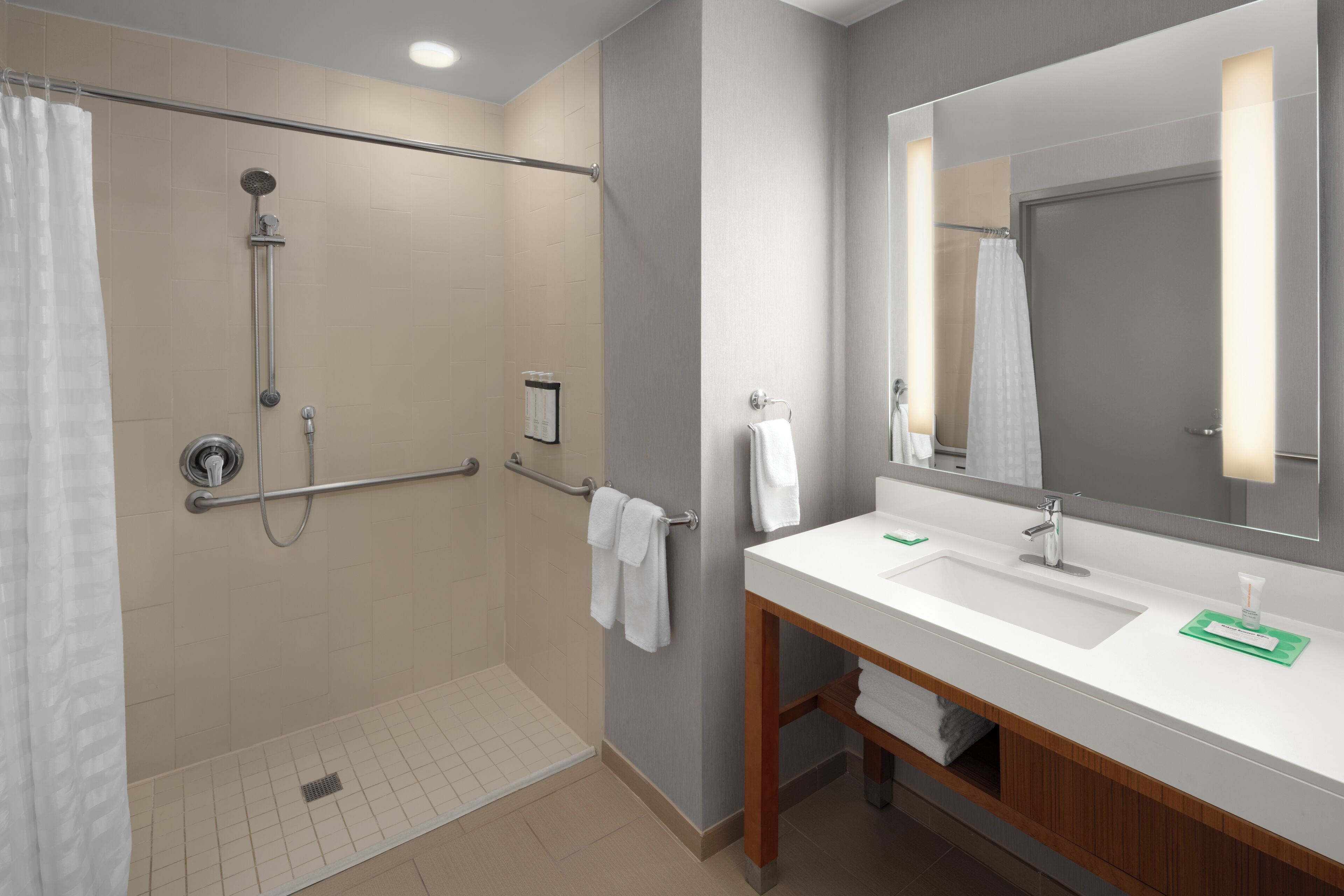 accessible king | bathroom | designer toiletries, hair dryer, towels, soap